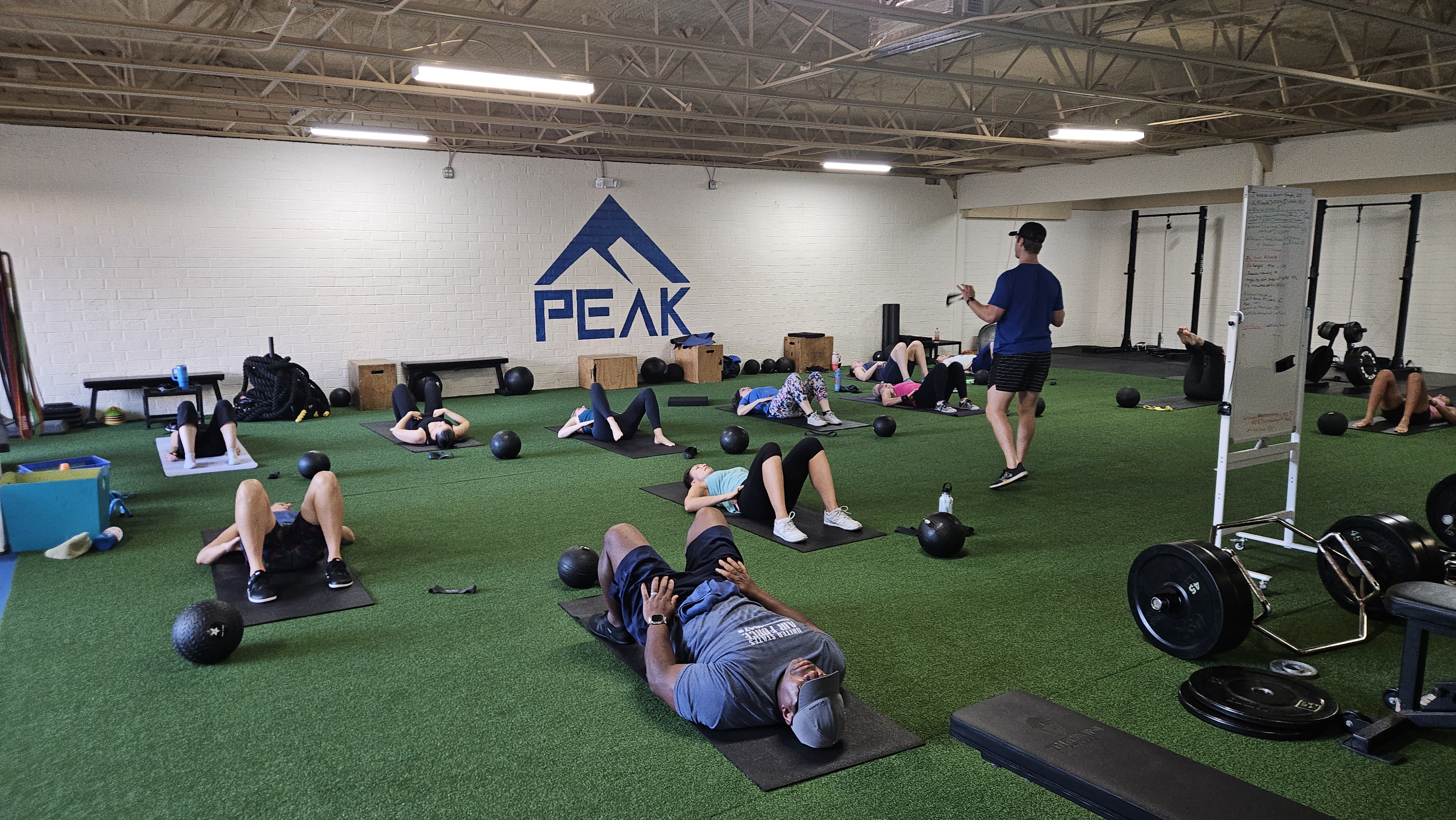 Members in a group strength class at Peak
