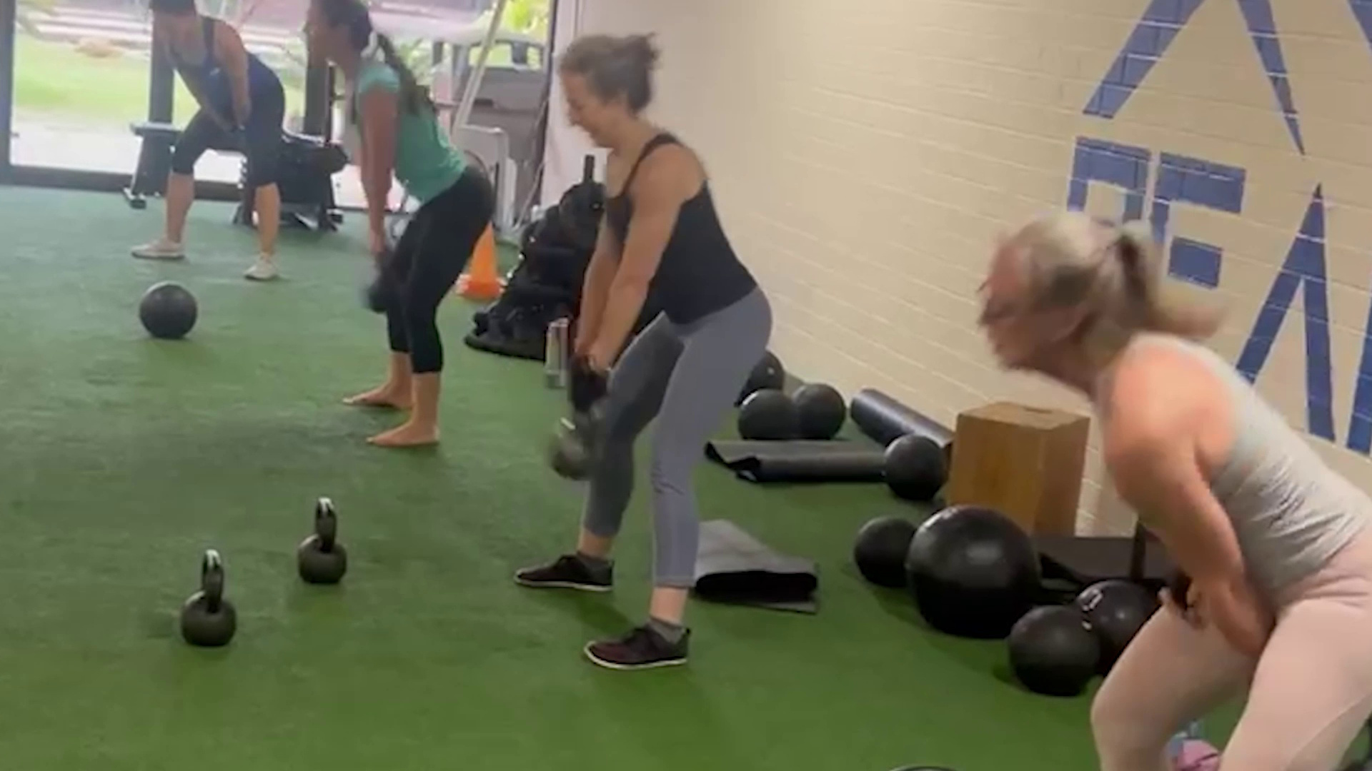 Members training with medicine balls in a group class at Peak Strength and Fitness