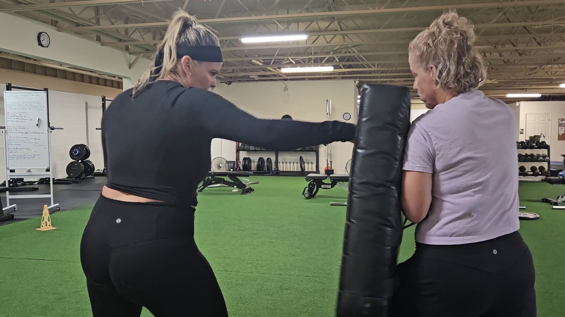 Two practitioners drilling stick work at Peak Martial Arts