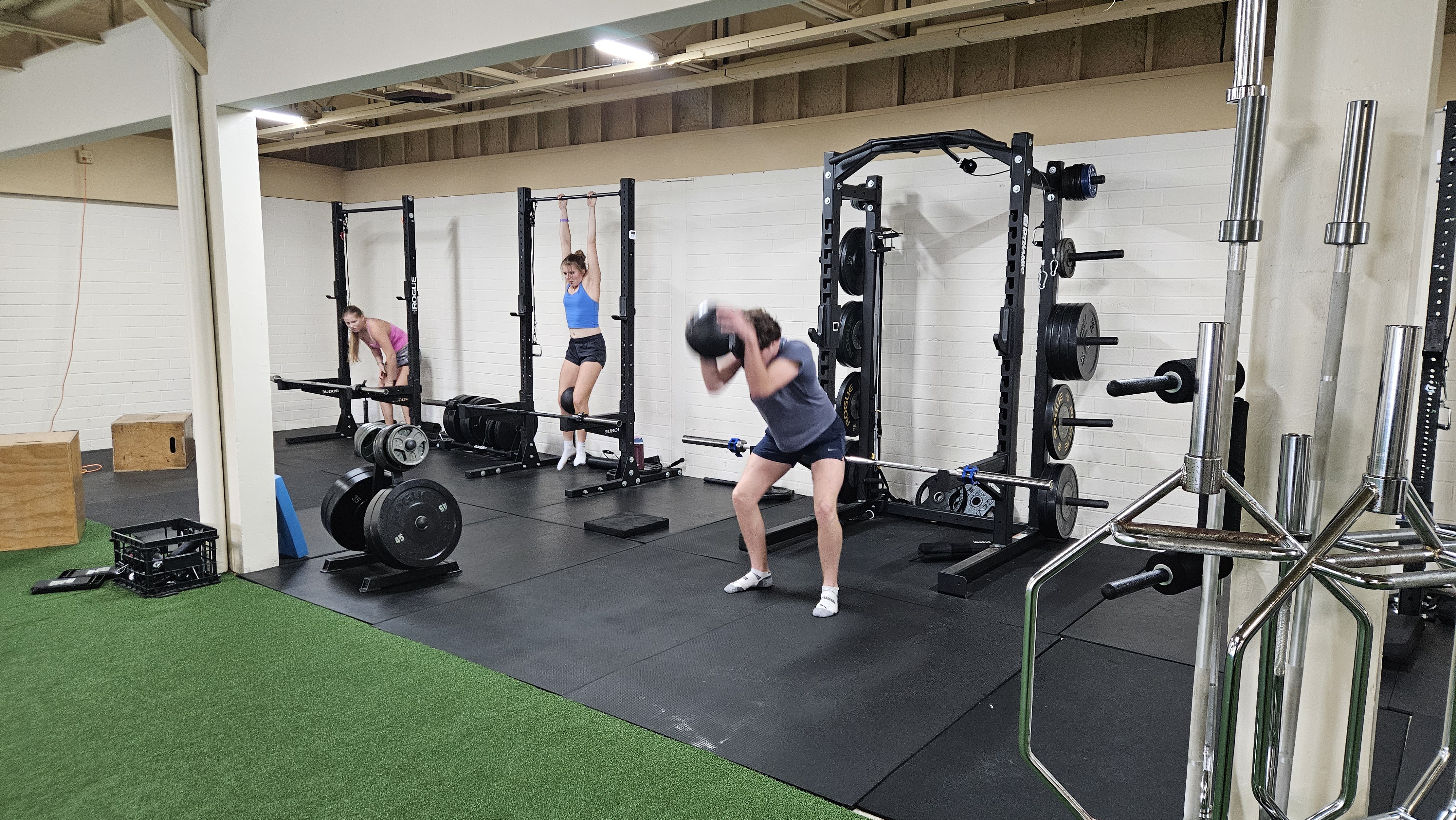 A teen athlete on the agility ladder with a coach